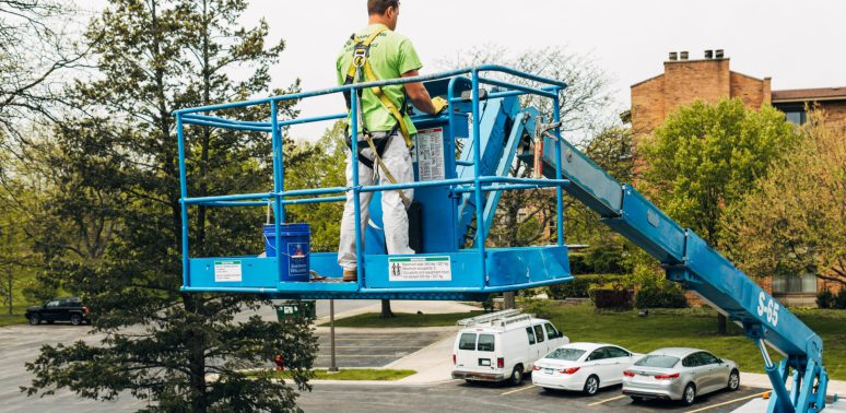 painter on high reach machine